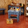 Bild von  Blauer Küchen-Weintisch mit Porzellanfliesen - dekoriert mit Käse und Weinflaschen