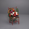 Picture of Red Metal chair decorated with many flowers