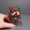 Picture of Red Metal chair decorated with many flowers
