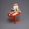 Bild von Geburtstagstisch mit Geschenken, Torte und Sekt